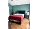Comfortable bedroom with a bed and two dark bedside tables and a wood-look floor at 6518 Garden Spring Ct, Orlando, FL 32818