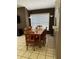 Cozy dining area with a wooden table and chairs, complemented by natural light from the window at 6518 Garden Spring Ct, Orlando, FL 32818