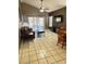 Spacious living room featuring tiled floors, a ceiling fan, and sliding glass doors to the backyard at 6518 Garden Spring Ct, Orlando, FL 32818