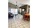 Spacious living room featuring tiled floors, a ceiling fan, and sliding glass doors to the backyard at 6518 Garden Spring Ct, Orlando, FL 32818