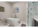 Modern bathroom featuring a standalone tub, glass-enclosed shower, and chic decor at 654 Mariposa St, Orlando, FL 32801