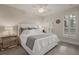 Cozy bedroom with plush carpeting, a large bed, and plantation shutters at 654 Mariposa St, Orlando, FL 32801