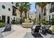 Community courtyard featuring a fountain, seating, mature palm trees and lush landscaping at 654 Mariposa St, Orlando, FL 32801