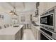 Gourmet kitchen with stainless steel appliances, a spacious island and pendant lighting at 654 Mariposa St, Orlando, FL 32801