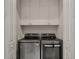 Convenient laundry room with a washer, dryer, and built-in storage cabinets at 654 Mariposa St, Orlando, FL 32801