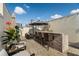 Rooftop deck with an outdoor kitchen, umbrella, and wicker chairs at 654 Mariposa St, Orlando, FL 32801