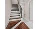 Elegant staircase with hardwood treads, white risers, and black iron railing at 654 Mariposa St, Orlando, FL 32801