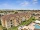 Aerial view of the complex featuring landscaped greenery, a pool, and multiple buildings at 724 Terrace Ridge Cir # 724, Davenport, FL 33896