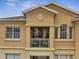 Close-up of an exterior balcony with a table, chairs, and plants that overlooks the community at 724 Terrace Ridge Cir # 724, Davenport, FL 33896