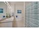 Bathroom offers dual sinks, a large mirror, and a shower-tub combination at 724 Terrace Ridge Cir # 724, Davenport, FL 33896