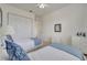 Cozy bedroom featuring two twin beds with blue accents, a ceiling fan, and closet at 724 Terrace Ridge Cir # 724, Davenport, FL 33896
