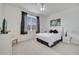 Bright bedroom features a plush bed, ceiling fan, and window with brown curtains at 724 Terrace Ridge Cir # 724, Davenport, FL 33896