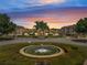 Community view with a fountain in the center and building in background during sunset at 724 Terrace Ridge Cir # 724, Davenport, FL 33896
