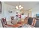Formal dining room featuring a wood table with seating for six and decorative chandelier at 724 Terrace Ridge Cir # 724, Davenport, FL 33896