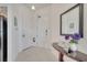 Bright entryway features a decorative table with mirror, and a view of the kitchen at 724 Terrace Ridge Cir # 724, Davenport, FL 33896