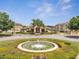 Community Clubhouse with well-maintained landscaping and a water fountain in the foreground at 724 Terrace Ridge Cir # 724, Davenport, FL 33896