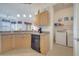 Features kitchen with a breakfast bar overlooking a laundry area with appliances at 724 Terrace Ridge Cir # 724, Davenport, FL 33896