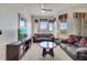 Spacious living room with sofas, a ceiling fan, and bright windows at 724 Terrace Ridge Cir # 724, Davenport, FL 33896