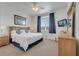 Cozy primary bedroom with a comfortable bed, serene decor, and natural light at 724 Terrace Ridge Cir # 724, Davenport, FL 33896