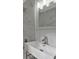 Modern bathroom with white marble tiling and fixtures, including a chrome faucet at 819 Edgewater Dr, Eustis, FL 32726
