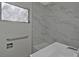 Bathroom with marbled tile backsplash, bright light, and a white sink at 819 Edgewater Dr, Eustis, FL 32726