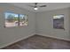 Bedroom featuring hardwood flooring, two windows, and neutral paint at 819 Edgewater Dr, Eustis, FL 32726