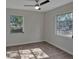 Bedroom with hardwood flooring, a ceiling fan, and plenty of natural light at 819 Edgewater Dr, Eustis, FL 32726