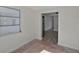 View of a hallway featuring neutral paint, wood-look flooring, and a window at 819 Edgewater Dr, Eustis, FL 32726