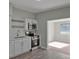 Modern kitchen featuring stainless steel appliances, white cabinets, and an undermount sink at 819 Edgewater Dr, Eustis, FL 32726