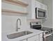 Modern kitchen featuring stainless steel appliances, white cabinetry and bright quartz countertops at 819 Edgewater Dr, Eustis, FL 32726