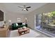 Bright living room with a comfortable couch, large window, and stylish decor at 819 Edgewater Dr, Eustis, FL 32726