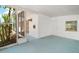 Spacious screened front porch with a white brick wall and entrance to the house at 819 Edgewater Dr, Eustis, FL 32726