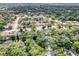 Aerial view of a residential neighborhood filled with lush trees and well-maintained homes and green spaces at 1039 Whispering Cv, Casselberry, FL 32707