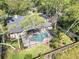 Aerial view showcasing the private screened-in pool, mature trees, and lush landscaping, creating a backyard oasis at 1039 Whispering Cv, Casselberry, FL 32707