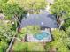 Aerial view of the home's backyard featuring a screened-in pool, lush landscaping, and privacy at 1039 Whispering Cv, Casselberry, FL 32707