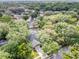 High angle aerial view of neighborhood with mature trees and a screened in pool at 1039 Whispering Cv, Casselberry, FL 32707
