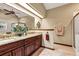 Bathroom with double sink vanity and granite countertops, plus a large mirror and unique lighting at 1039 Whispering Cv, Casselberry, FL 32707