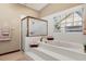 Bathroom featuring a soaking tub with tile surround and a glass enclosed shower at 1039 Whispering Cv, Casselberry, FL 32707