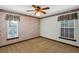 Bedroom with neutral carpet, and light walls, complemented by two windows with decorative valances at 1039 Whispering Cv, Casselberry, FL 32707