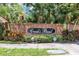 Entrance to the Creek's Bend neighborhood with brick wall and lush landscaping at 1039 Whispering Cv, Casselberry, FL 32707