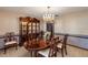 A formal dining area features a refined hutch, an oval table, and decorative wallpaper, exuding an elegant charm at 1039 Whispering Cv, Casselberry, FL 32707