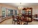 The dining room is illuminated by a sparkling chandelier and features a large bay window with views of the outdoors at 1039 Whispering Cv, Casselberry, FL 32707