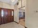 A cozy entryway boasts a solid wood front door, neutral walls, and tiled flooring for a welcoming ambiance at 1039 Whispering Cv, Casselberry, FL 32707
