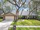 Charming home with mature trees, brick accents, lush landscaping, and well-maintained lawn at 1039 Whispering Cv, Casselberry, FL 32707
