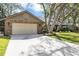 Charming brick home with lush landscaping, two-car garage, and a well-maintained driveway at 1039 Whispering Cv, Casselberry, FL 32707