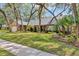 Charming brick home with mature trees, well-manicured lawn, and lush landscaping at 1039 Whispering Cv, Casselberry, FL 32707