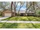Charming brick home with mature trees, well-manicured lawn, and attached two car garage at 1039 Whispering Cv, Casselberry, FL 32707
