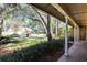 Covered front porch with brick flooring, white columns, and scenic neighborhood views at 1039 Whispering Cv, Casselberry, FL 32707