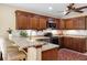 This kitchen showcases stainless steel appliances, granite countertops, and rich wooden cabinets at 1039 Whispering Cv, Casselberry, FL 32707