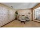 Cozy living room with floral wallpaper, vintage sofa, and natural light at 1039 Whispering Cv, Casselberry, FL 32707